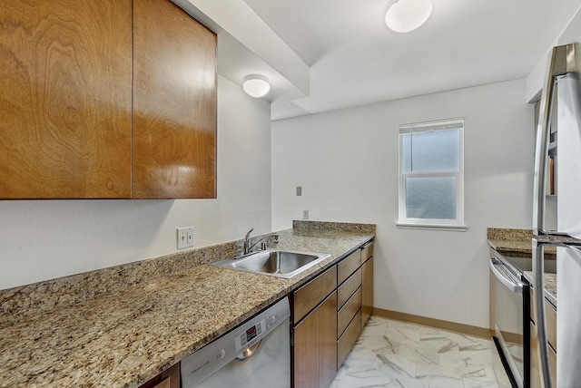 6125 N Addison St, Spokane, WA 99208 - kitchen featuring stainless steel appliances, light marble finish flooring, brown cabinets, and light stone countertops