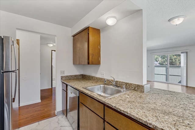 6125 N Addison St, Spokane, WA 99208 - kitchen with stainless steel appliances, light countertops, brown cabinets, and light marble finish flooring