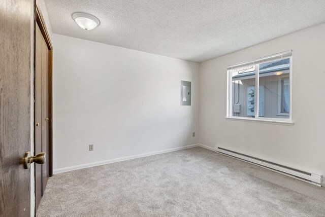 6125 N Addison St, Spokane, WA 99208 - empty room featuring baseboard heating, electric panel, carpet floors, and a textured ceiling