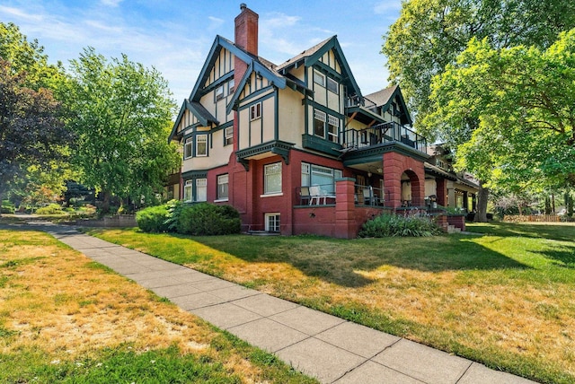 903 S Adams St, Spokane, WA 99204 - view of side of home with a chimney, a lawn, a balcony, and stucco siding