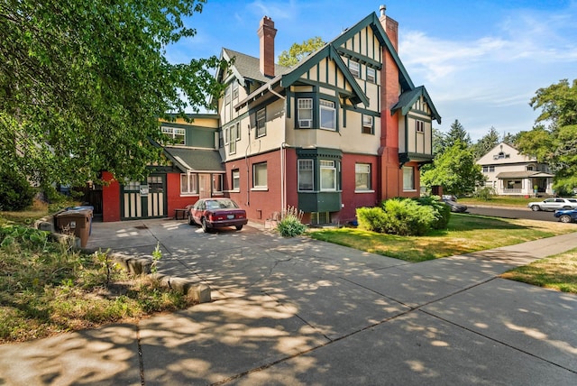903 S Adams St, Spokane, WA 99204 - view of front of home featuring a chimney, stucco siding, and brick siding