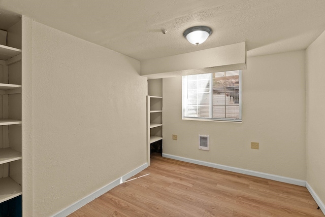 903 S Adams St, Spokane, WA 99204 - unfurnished bedroom featuring wood finished floors, a textured ceiling, and a textured wall