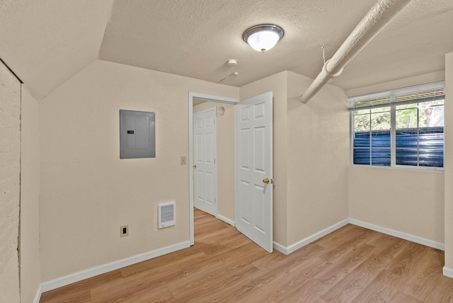 903 S Adams St, Spokane, WA 99204 - spare room featuring electric panel, light wood finished floors, a textured ceiling, and lofted ceiling
