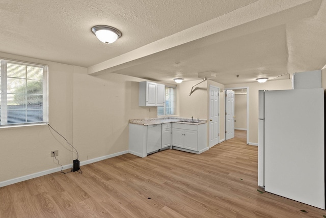903 S Adams St, Spokane, WA 99204 - kitchen featuring white appliances, light wood finished floors, light countertops, white cabinets, and a textured ceiling