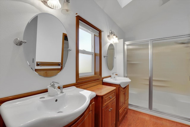 8722 E Boardwalk Ln, Spokane, WA 99212 - full bathroom featuring a shower stall, two vanities, wood finished floors, and lofted ceiling