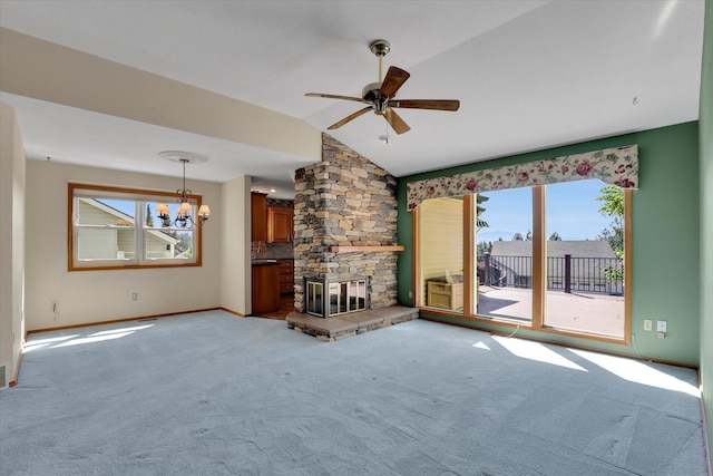8722 E Boardwalk Ln, Spokane, WA 99212 - unfurnished living room with vaulted ceiling, light colored carpet, a chandelier, a stone fireplace, and healthy amount of natural light