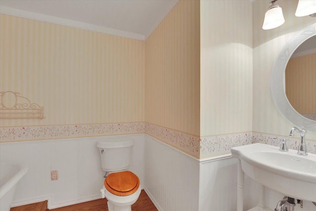 8722 E Boardwalk Ln, Spokane, WA 99212 - bathroom featuring wallpapered walls, wainscoting, and wood finished floors