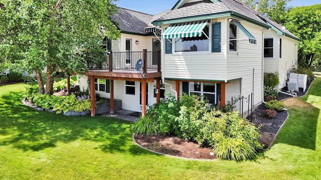 8722 E Boardwalk Ln, Spokane, WA 99212 - back of house featuring a lawn and a wooden deck