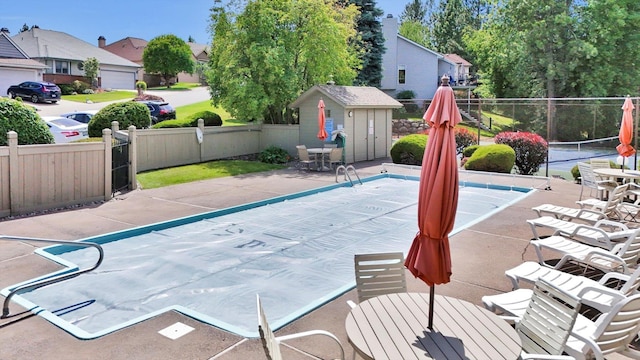 8722 E Boardwalk Ln, Spokane, WA 99212 - view of pool with a tennis court, a residential view, a storage shed, and outdoor dining space