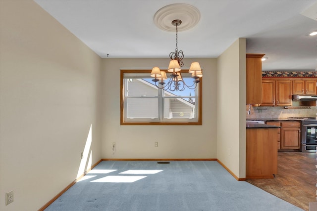 8722 E Boardwalk Ln, Spokane, WA 99212 - unfurnished dining area with a chandelier and dark colored carpet
