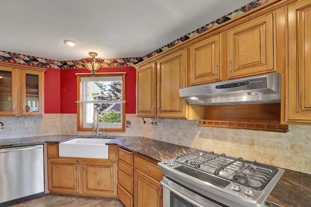 8722 E Boardwalk Ln, Spokane, WA 99212 - kitchen featuring appliances with stainless steel finishes, under cabinet range hood, brown cabinetry, and decorative backsplash