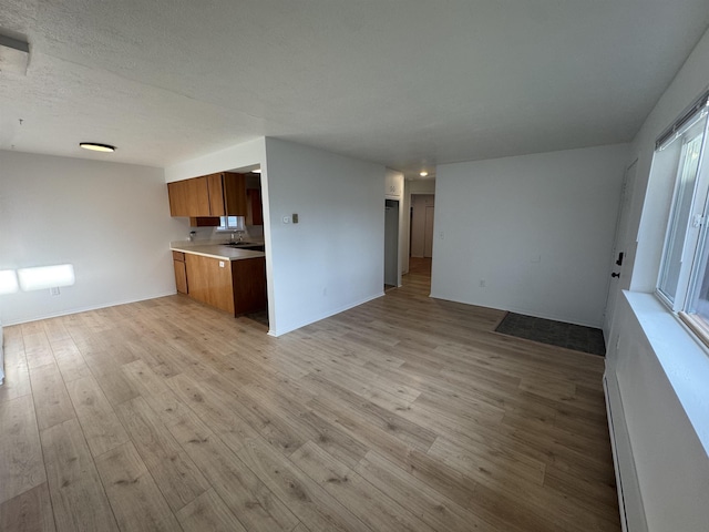 824-830 E N Ave, Spokane, WA 99207 - unfurnished living room with light wood-style floors and baseboard heating