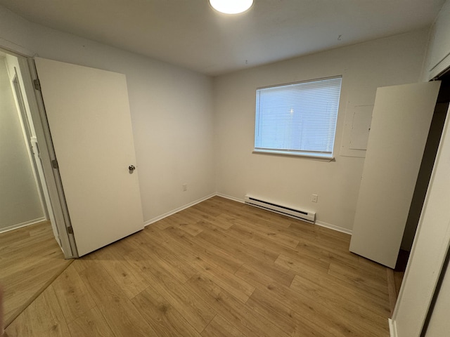 824-830 E N Ave, Spokane, WA 99207 - unfurnished bedroom featuring a baseboard heating unit and light wood finished floors