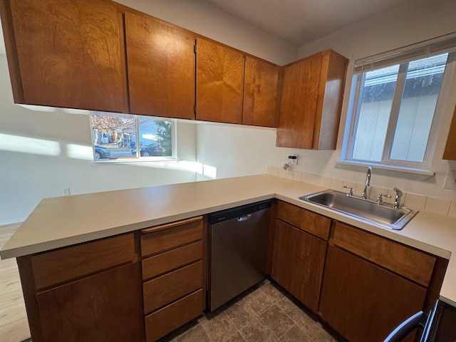 824-830 E N Ave, Spokane, WA 99207 - kitchen with stainless steel dishwasher, light countertops, a peninsula, and brown cabinetry