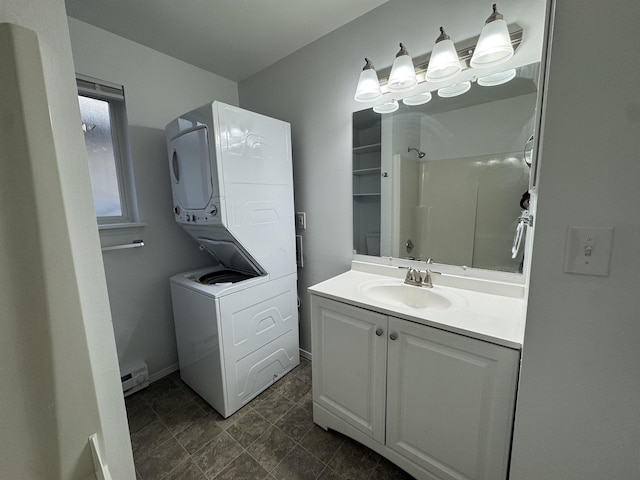 824-830 E N Ave, Spokane, WA 99207 - bathroom with stacked washer and clothes dryer, vanity, a shower, and a baseboard heating unit
