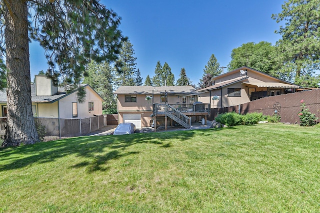 4232 E 10th Ave, Spokane, WA 99202 - back of property featuring stairs, a fenced backyard, a deck, and an attached garage