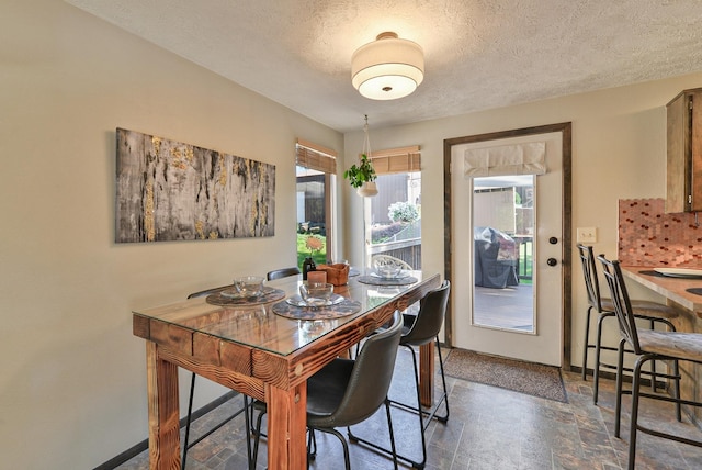 4232 E 10th Ave, Spokane, WA 99202 - dining room with dark stone finish flooring and a textured ceiling