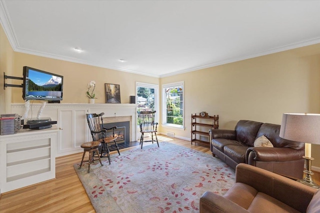 2718 S Hatch St, Spokane, WA 99203 - living room with crown molding, a glass covered fireplace, and light wood-style flooring