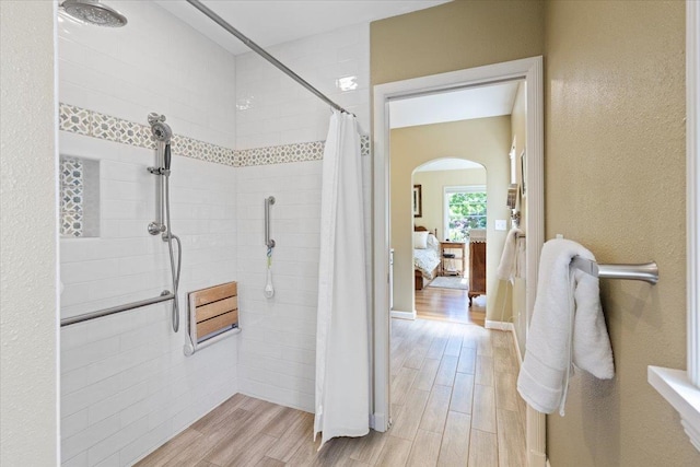 2718 S Hatch St, Spokane, WA 99203 - full bathroom with wood finished floors, tiled shower, and ensuite bathroom