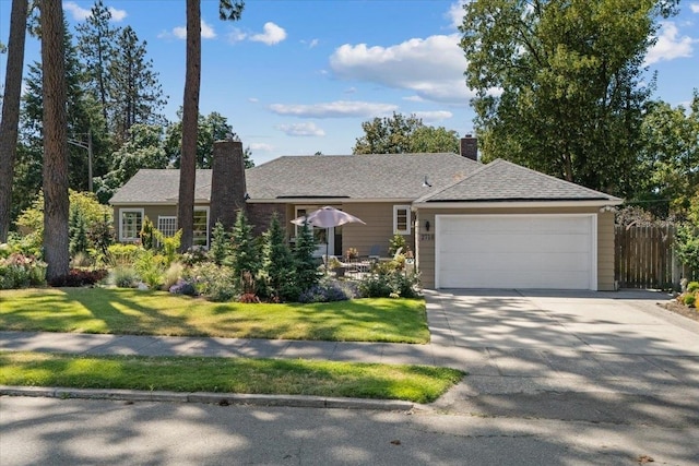 2718 S Hatch St, Spokane, WA 99203 - view of front of home with a garage, concrete driveway, and a chimney