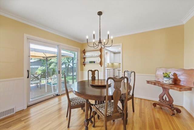 2718 S Hatch St, Spokane, WA 99203 - dining room featuring a chandelier, light wood-type flooring, crown molding, and a wainscoted wall