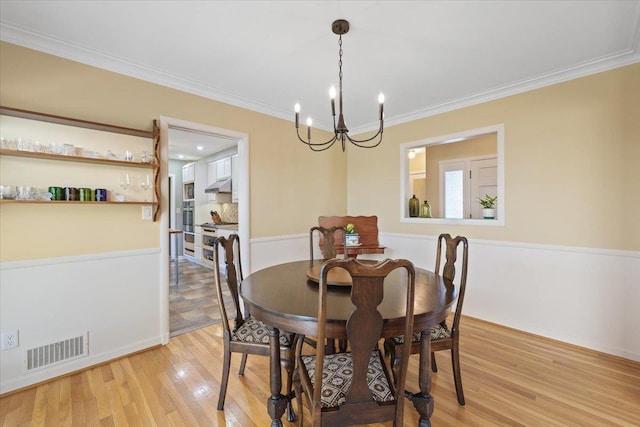 2718 S Hatch St, Spokane, WA 99203 - dining room with light wood-type flooring, a chandelier, and ornamental molding