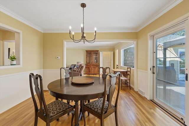 2718 S Hatch St, Spokane, WA 99203 - dining room featuring light wood-type flooring, a chandelier, and ornamental molding