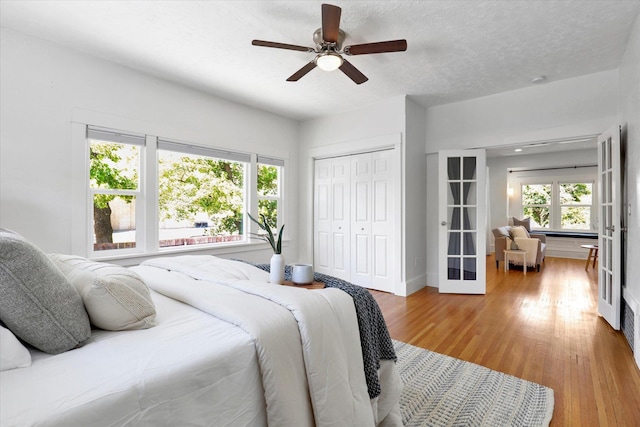 2116 N Jefferson St, Spokane, WA 99205 - bedroom featuring light wood finished floors, a closet, french doors, and a ceiling fan