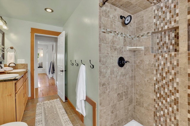 2116 N Jefferson St, Spokane, WA 99205 - bathroom featuring a tile shower, double vanity, tile patterned flooring, and recessed lighting