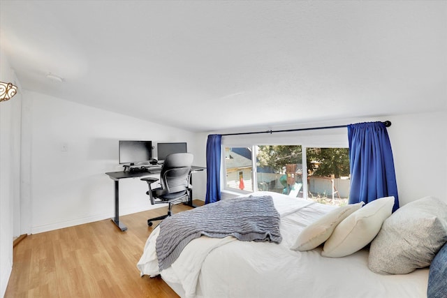2116 N Jefferson St, Spokane, WA 99205 - bedroom with vaulted ceiling, light wood finished floors, a desk, and access to outside