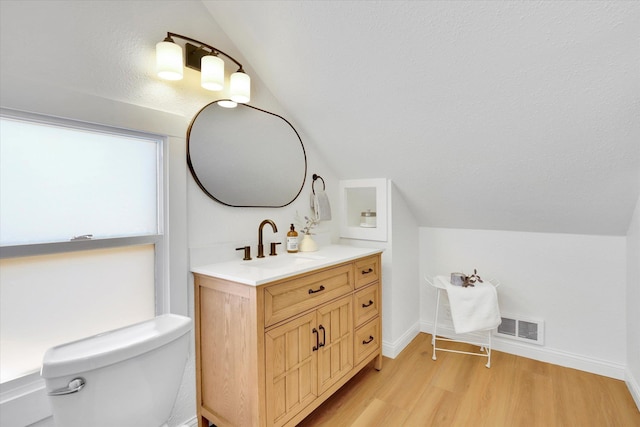 2116 N Jefferson St, Spokane, WA 99205 - bathroom featuring lofted ceiling, wood finished floors, and vanity