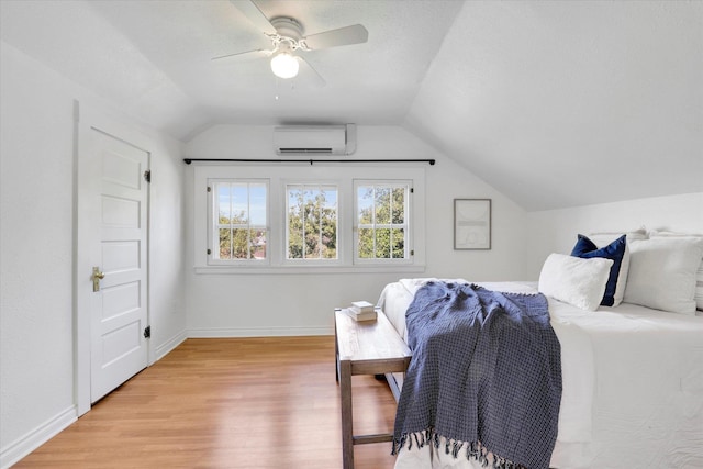 2116 N Jefferson St, Spokane, WA 99205 - bedroom featuring a wall mounted air conditioner, vaulted ceiling, light wood finished floors, and a ceiling fan
