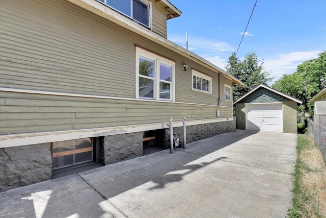 2116 N Jefferson St, Spokane, WA 99205 - view of property exterior with driveway, a detached garage, and an outdoor structure