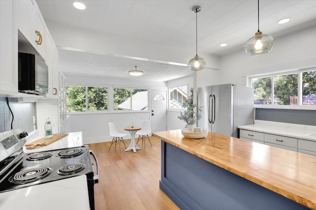 2116 N Jefferson St, Spokane, WA 99205 - kitchen featuring stainless steel appliances, butcher block counters, plenty of natural light, light wood-style flooring, and recessed lighting