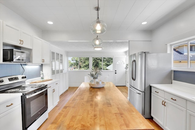 2116 N Jefferson St, Spokane, WA 99205 - kitchen with stainless steel appliances, light wood-type flooring, white cabinets, and recessed lighting