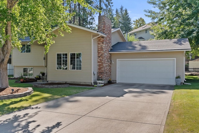 11919 S Player Dr, Spokane, WA 99223 - view of front of home with concrete driveway, a chimney, an attached garage, and a front yard