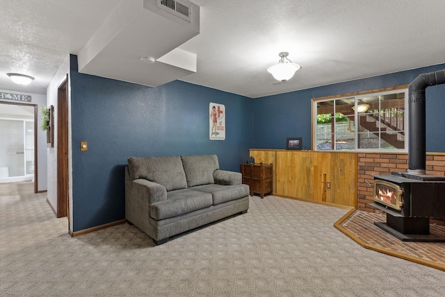 11919 S Player Dr, Spokane, WA 99223 - living area featuring carpet flooring, a textured ceiling, and a wood stove