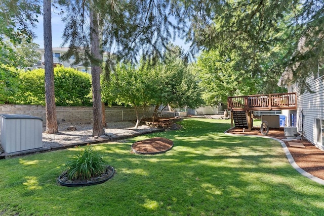 11919 S Player Dr, Spokane, WA 99223 - fenced backyard featuring stairway, a deck, and a storage unit