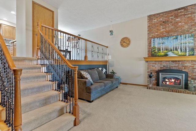 11919 S Player Dr, Spokane, WA 99223 - carpeted living room with a fireplace, stairway, and recessed lighting