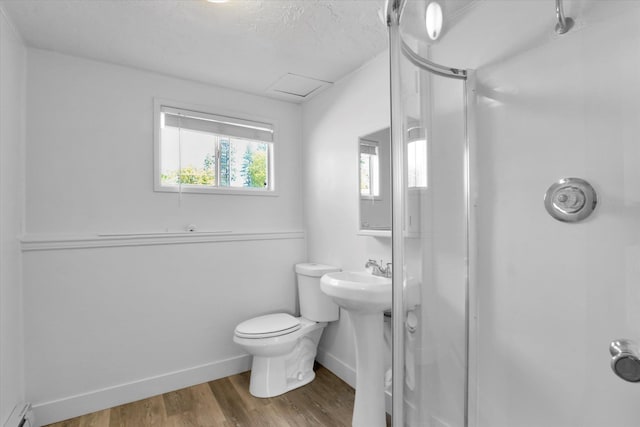 10109 E 9th Ave, Spokane Valley, WA 99206 - full bath featuring a baseboard heating unit, a stall shower, and wood finished floors