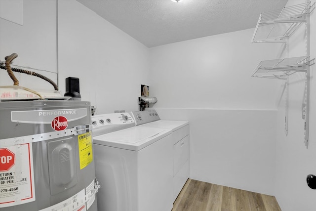 10109 E 9th Ave, Spokane Valley, WA 99206 - washroom with electric water heater, separate washer and dryer, wood finished floors, and a textured ceiling