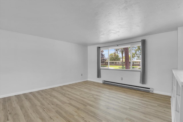 10109 E 9th Ave, Spokane Valley, WA 99206 - spare room with a baseboard radiator and light wood finished floors