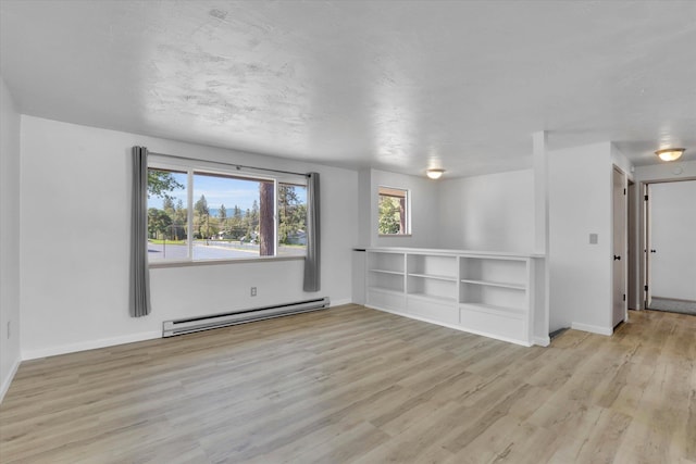 10109 E 9th Ave, Spokane Valley, WA 99206 - spare room featuring a baseboard heating unit and light wood-type flooring