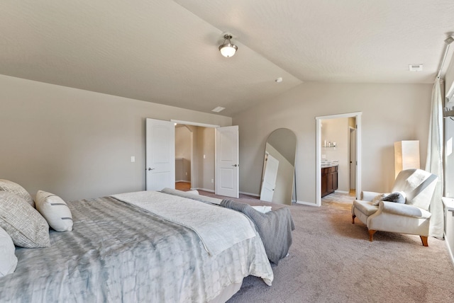 1115 S Mcmillan Rd, Spokane Valley, WA 99016 - bedroom featuring vaulted ceiling, light carpet, and ensuite bath