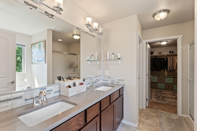 1115 S Mcmillan Rd, Spokane Valley, WA 99016 - bathroom featuring a shower stall, double vanity, and a walk in closet