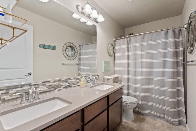 1115 S Mcmillan Rd, Spokane Valley, WA 99016 - bathroom featuring double vanity, tasteful backsplash, and curtained shower