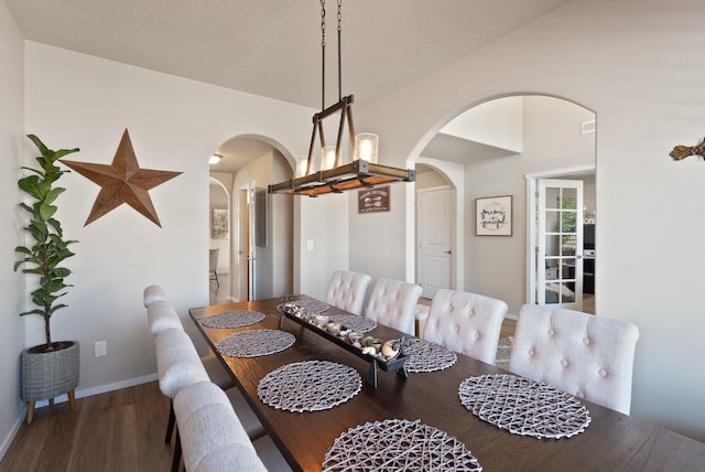 1115 S Mcmillan Rd, Spokane Valley, WA 99016 - dining space with arched walkways, wood finished floors, and lofted ceiling