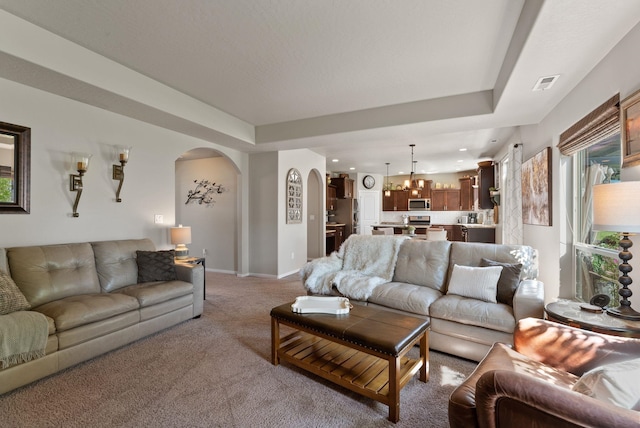 1115 S Mcmillan Rd, Spokane Valley, WA 99016 - living area featuring arched walkways, light carpet, a chandelier, and recessed lighting