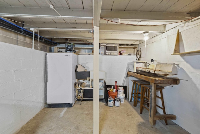 7225 E 11th Ave, Spokane, WA 99212 - unfinished basement featuring freestanding refrigerator and concrete block wall