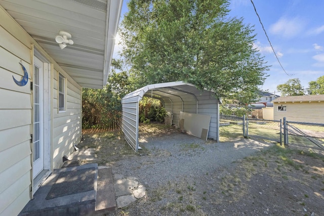 7225 E 11th Ave, Spokane, WA 99212 - view of car parking featuring a carport, driveway, and a gate
